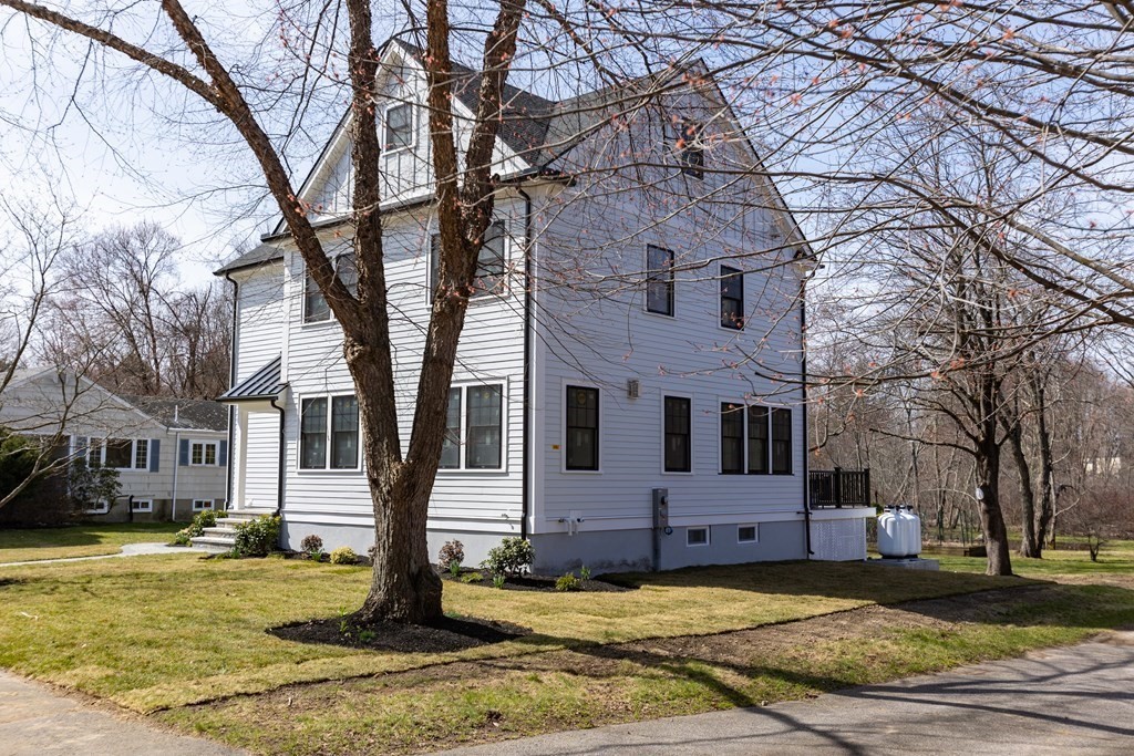 14 Lexington Road Wellesley, MA 02482 - Photo 1 of 19 a view of a brick house next to a yard with large trees