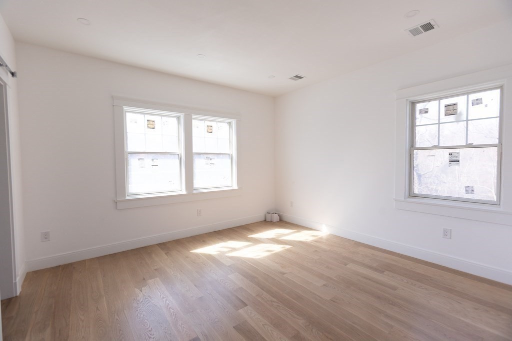 14 Lexington Road Wellesley, MA 02482 - Photo 13 of 19 an empty room with wooden floor and windows