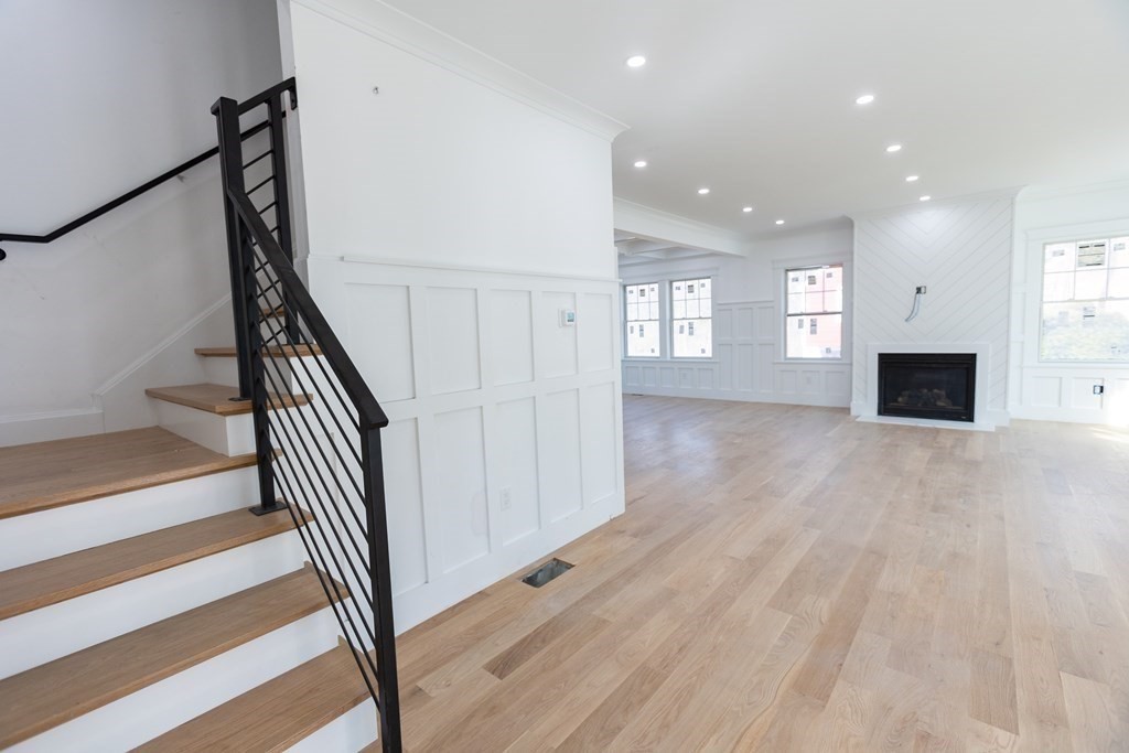 14 Lexington Road Wellesley, MA 02482 - Photo 3 of 19 a view of empty room with wooden floor and fireplace