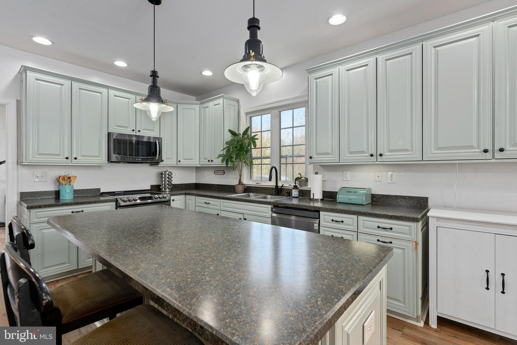 4525 Beckleysville Road Hampstead, MD 21074 - Photo 17 of 80 a kitchen with kitchen island a stove sink and microwave