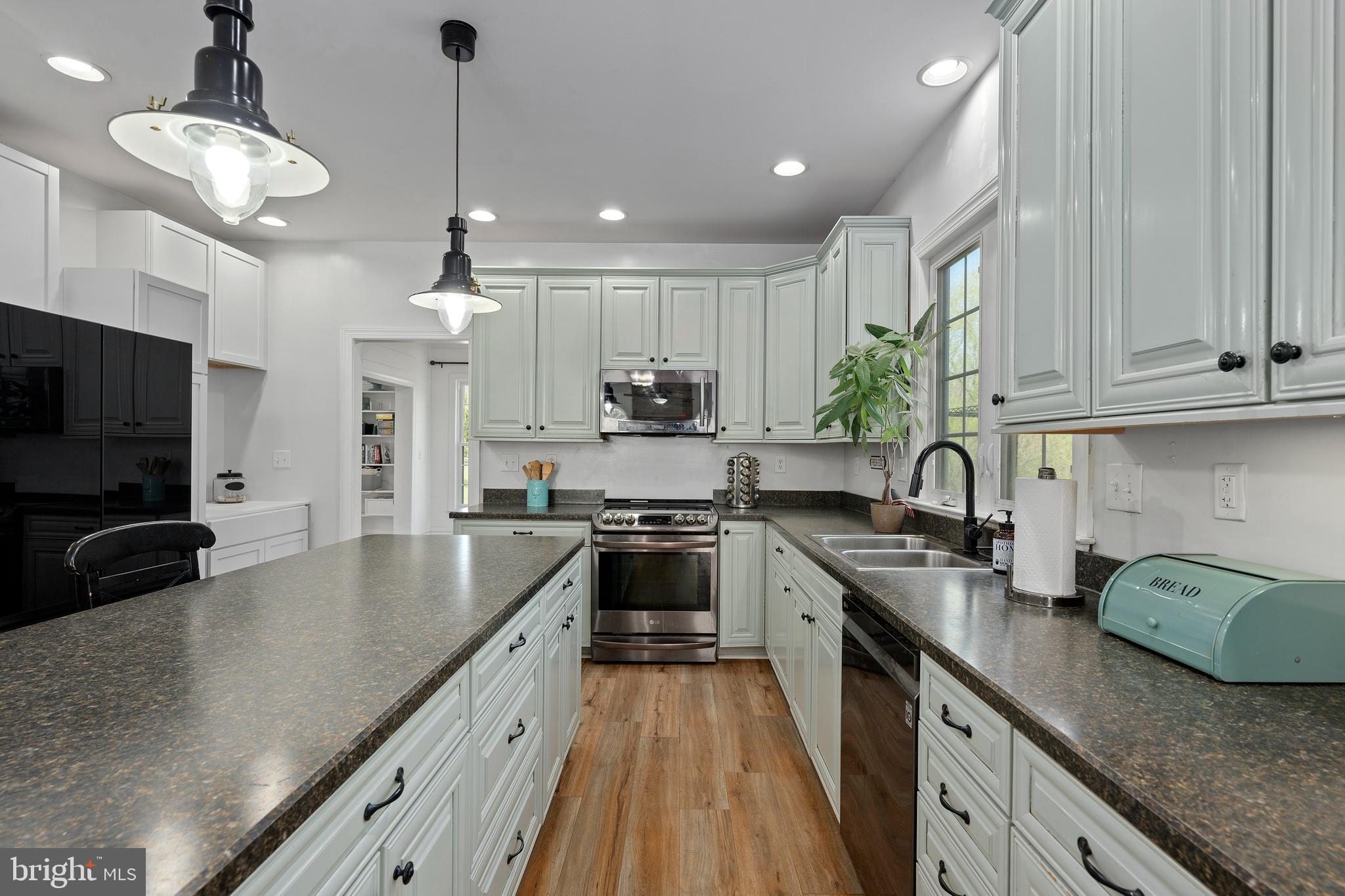 4525 Beckleysville Road Hampstead, MD 21074 - Photo 18 of 80 a kitchen with stainless steel appliances granite countertop a sink a stove and a refrigerator