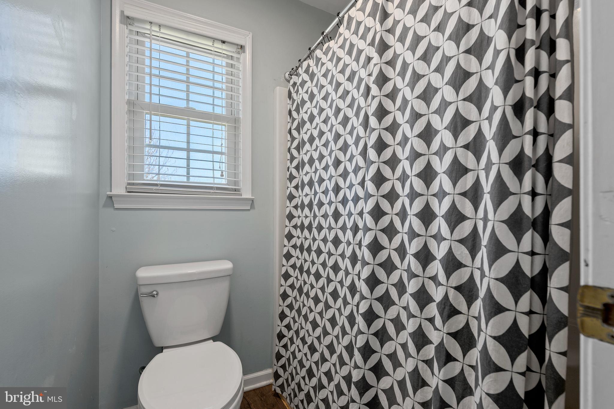 4525 Beckleysville Road Hampstead, MD 21074 - Photo 41 of 80 a white toilet sitting next to a shower curtain