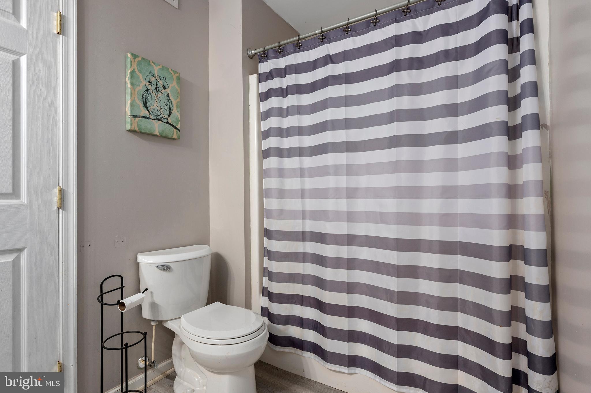 4525 Beckleysville Road Hampstead, MD 21074 - Photo 47 of 80 a white toilet sitting next to a shower curtain