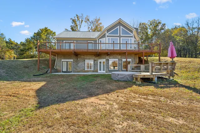 a view of a house with a yard and sitting area