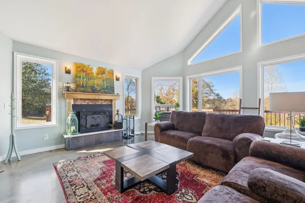 a living room with furniture and a chandelier