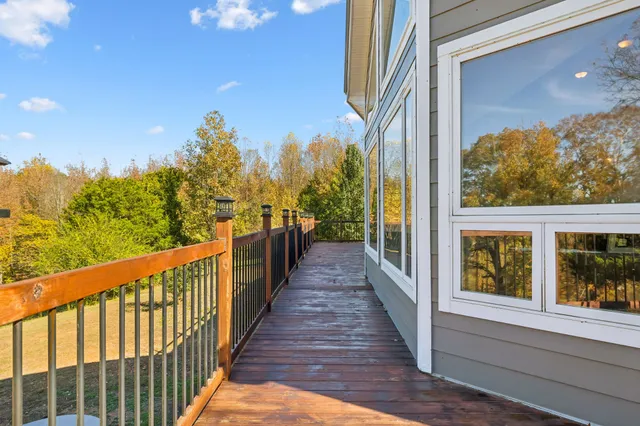 a view of an empty room with wooden floor and a bathroom