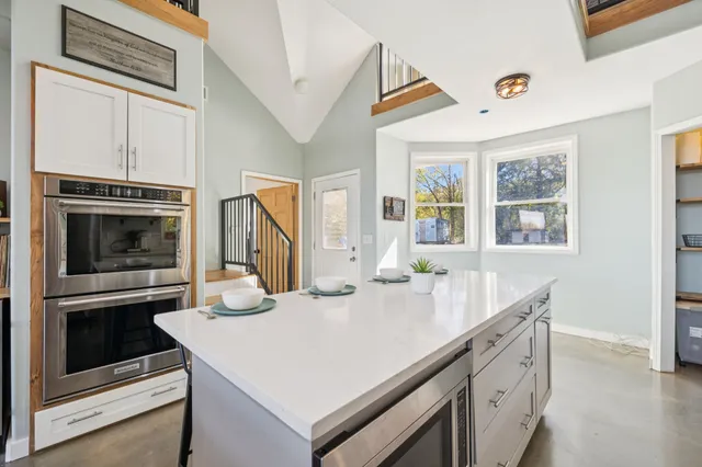 a living room with furniture fireplace and a large window