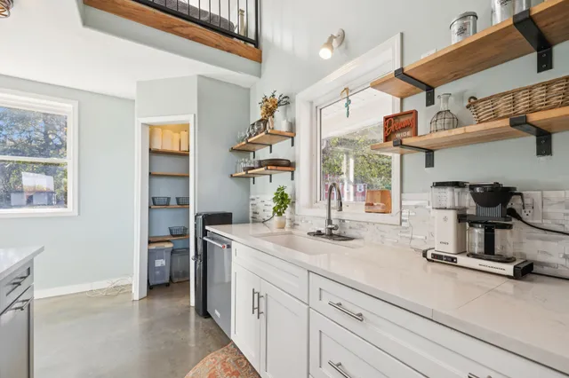 a view of a livingroom with wooden floor and staircase