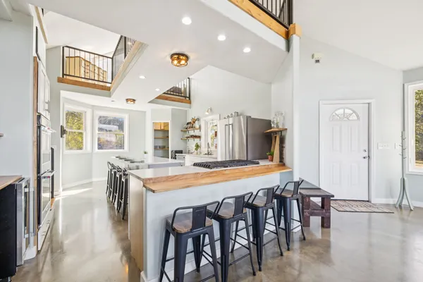 a kitchen with a stove a sink and a refrigerator