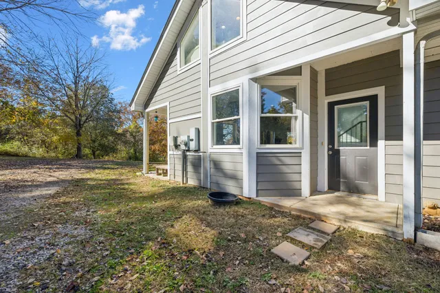 a spacious bedroom with a large bed and a chandelier
