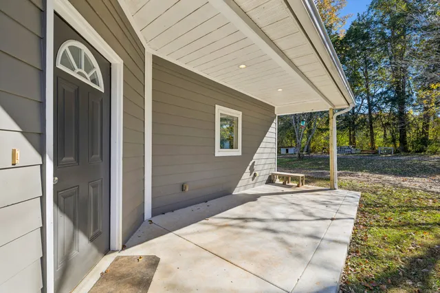 a view of hallway with wooden floor and windows