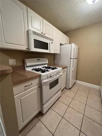 a kitchen with cabinets and steel appliances