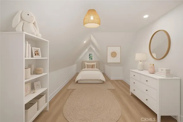 a spacious bedroom with a bed and a chandelier