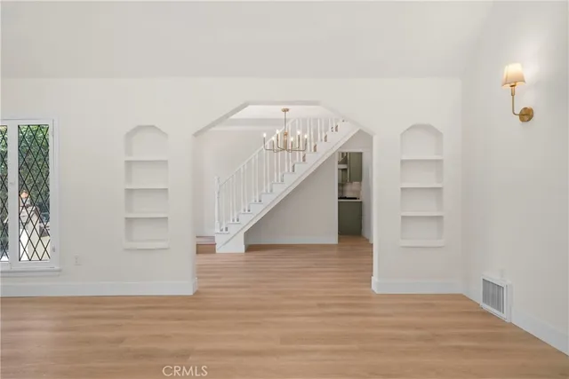 a view of entryway and hall with wooden floor