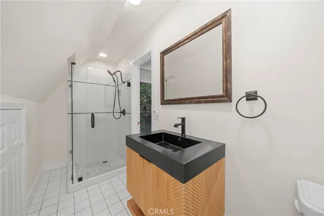a bathroom with a sink a mirror and shower