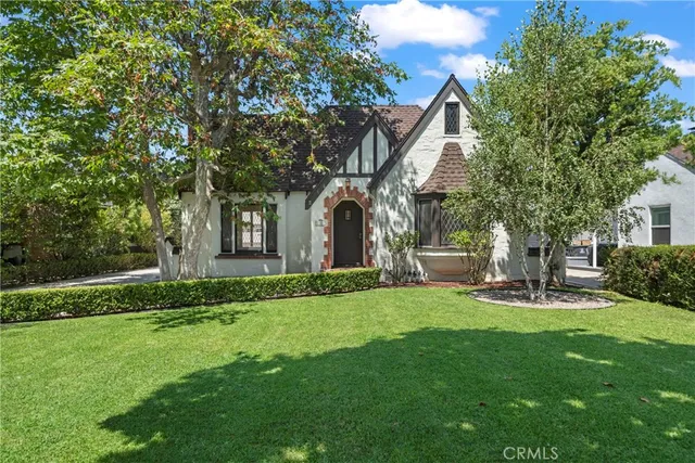 a view of a house with a yard and sitting area