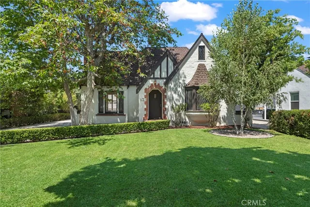 a view of a house with a yard and sitting area