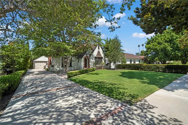 a view of a house with yard and a garden