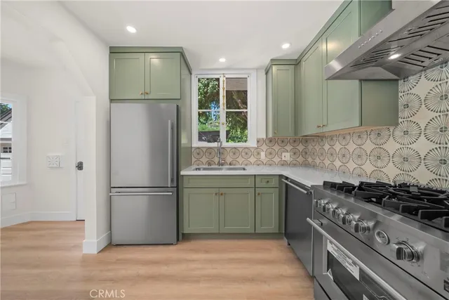 a kitchen with a refrigerator and a sink