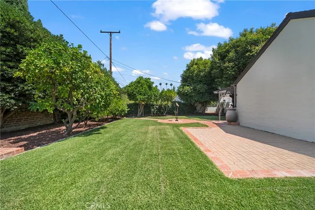 a view of a backyard with swimming pool