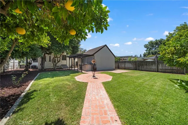 a front view of a house with a garden and yard