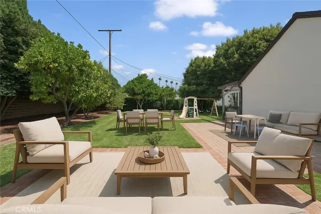 a view of backyard with seating area and green space