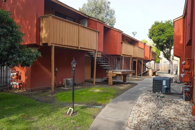 a view of a house with a yard and sitting area