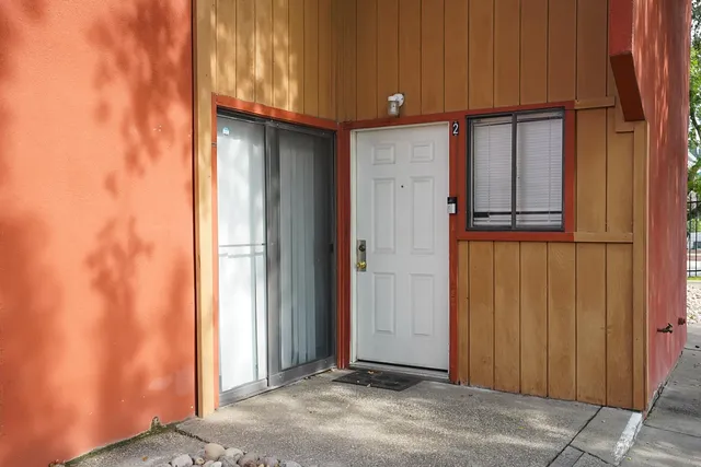a view of a door and chair in the balcony
