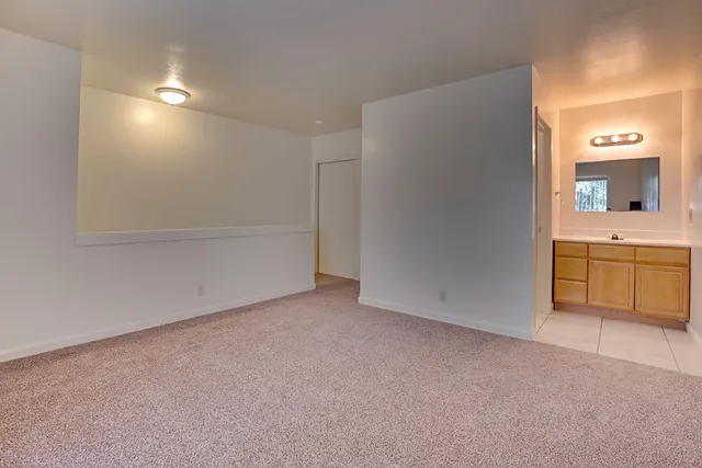 a bathroom with a toilet sink vanity and mirror