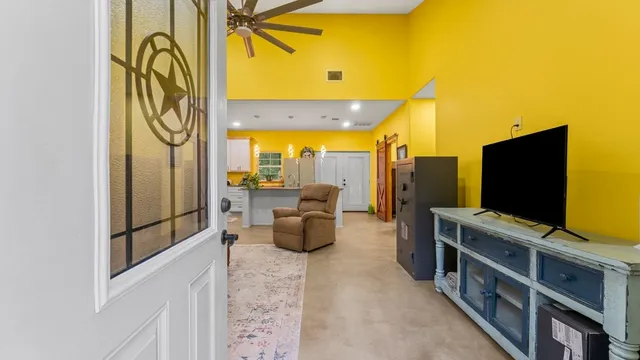 a living room with furniture and a flat screen tv