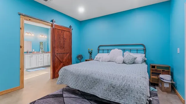 a bedroom with a bed and a view of bathroom