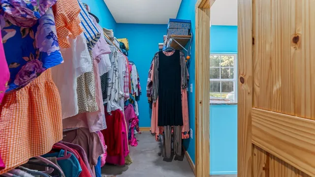 a view of walk in closet with clothes