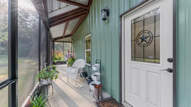 a balcony with furniture and a large window
