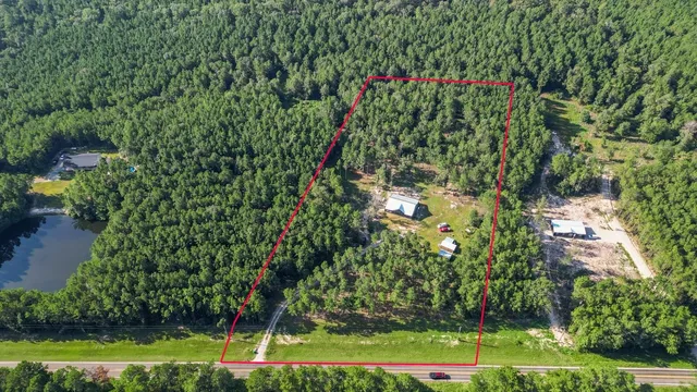 a backyard of a house with lots of green space and trees