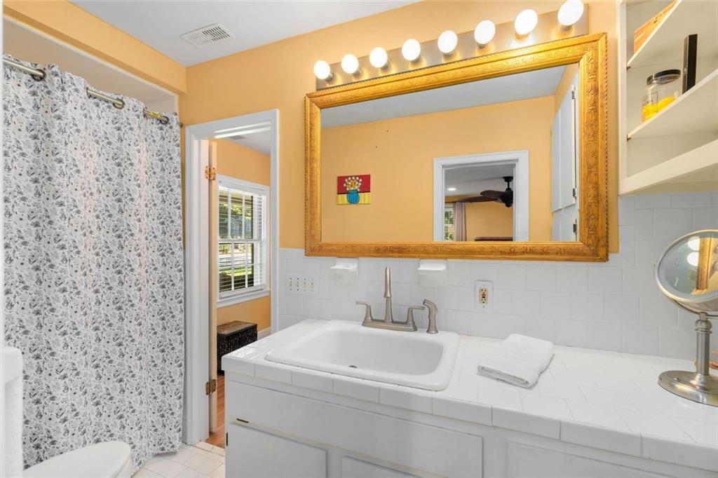 601 Ridgewood Avenue Gainesville, GA 30501 - Photo 15 of 36 a bathroom with a sink a mirror and a toilet