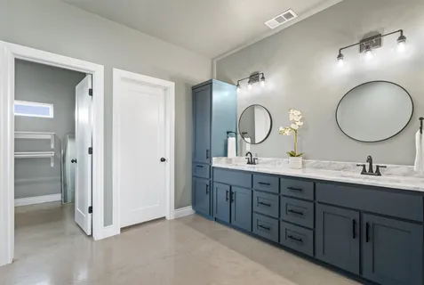 a bathroom with a double vanity sink and a mirror