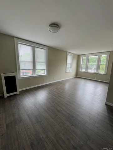 a view of a livingroom with wooden floor and window