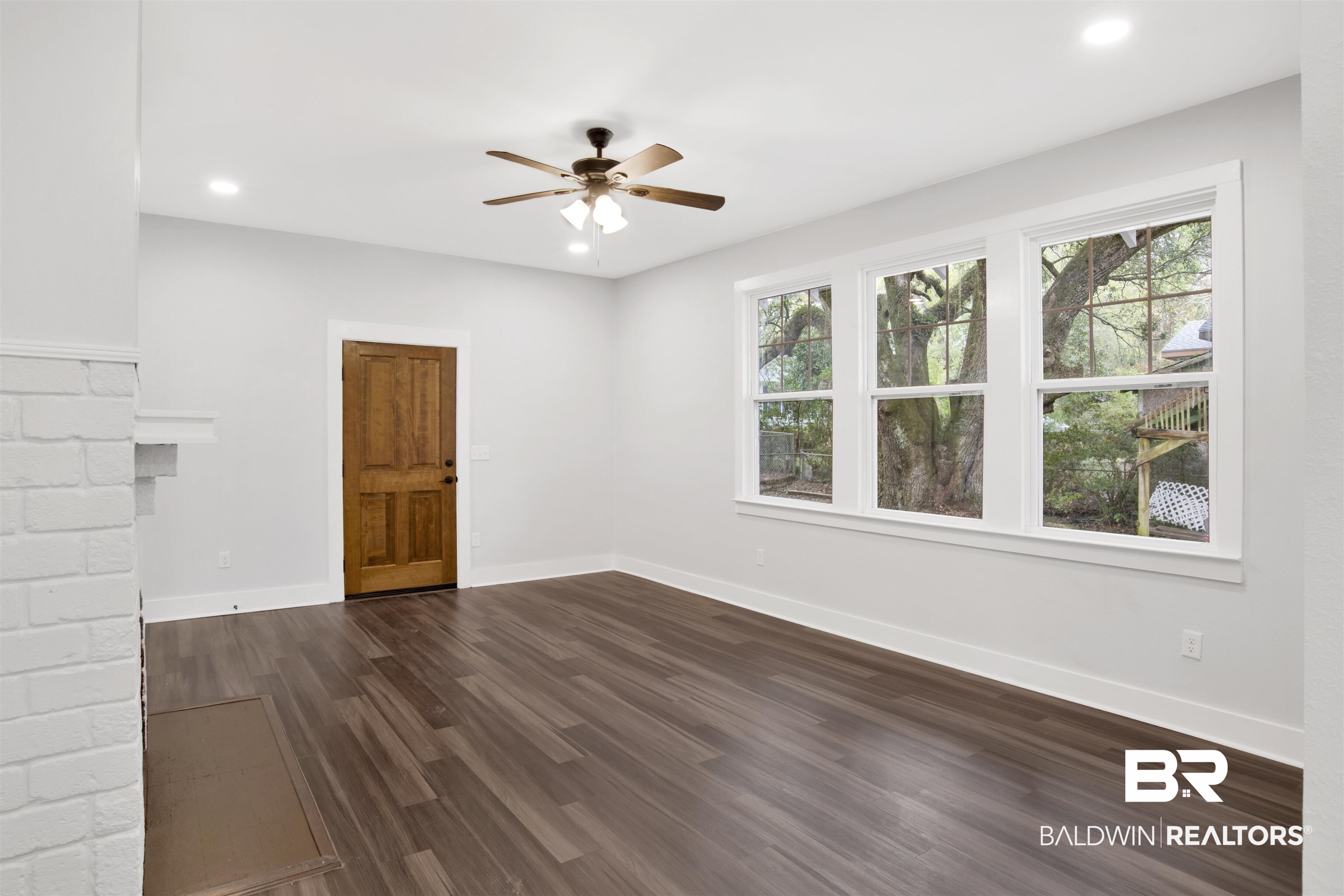 302 1st Street Mobile, AL 36611 - Photo 9 of 28 Unfurnished room with dark wood-type flooring, ceiling fan, and a wealth of natural light