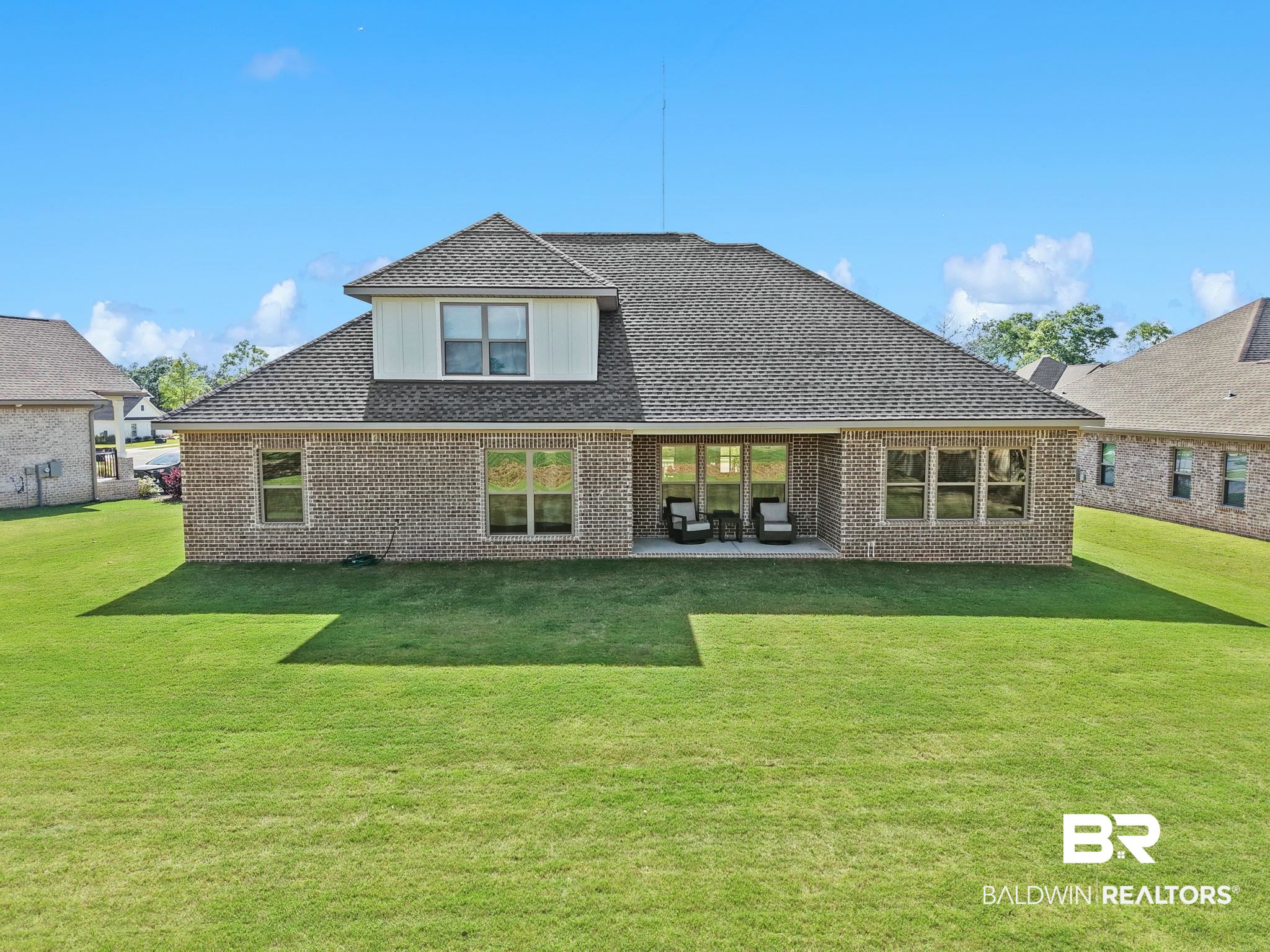 12132 Exbury Way Daphne, AL 36527 - Photo 33 of 47 Back of house featuring a patio, a yard, brick siding, and a shingled roof