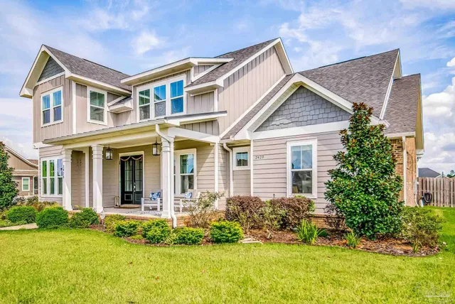 a view of a room with wooden floor lounge chair and windows
