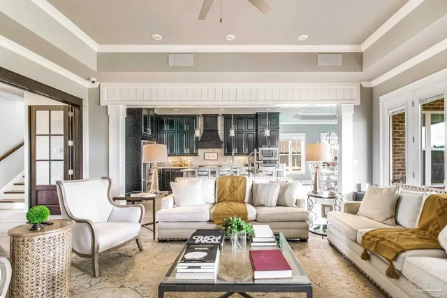 a living room with furniture a rug and a large window