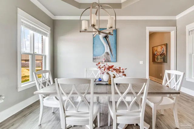 a view of a big yard with a large tree and wooden fence