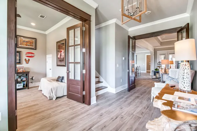 a kitchen with stainless steel appliances granite countertop a kitchen island a stove a sink a dining table and chairs