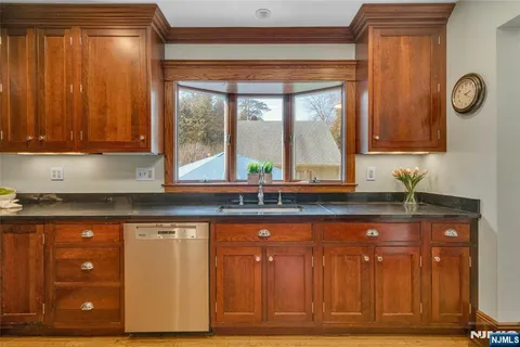 a kitchen with granite countertop wooden cabinets and a granite counter top