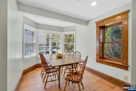 a view of a dining room with furniture large windows and wooden floor