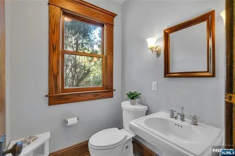a bathroom with a sink mirror and toilet