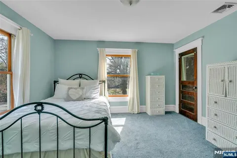 a bedroom with a bed and a table