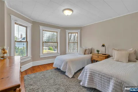 a bedroom with two beds and a large window