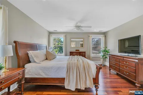 a bedroom with a bed and a flat screen television