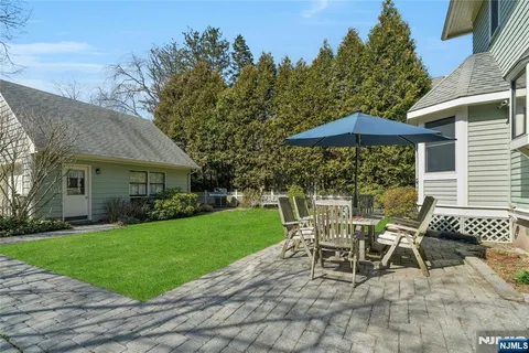 a patio with a patio table and chairs